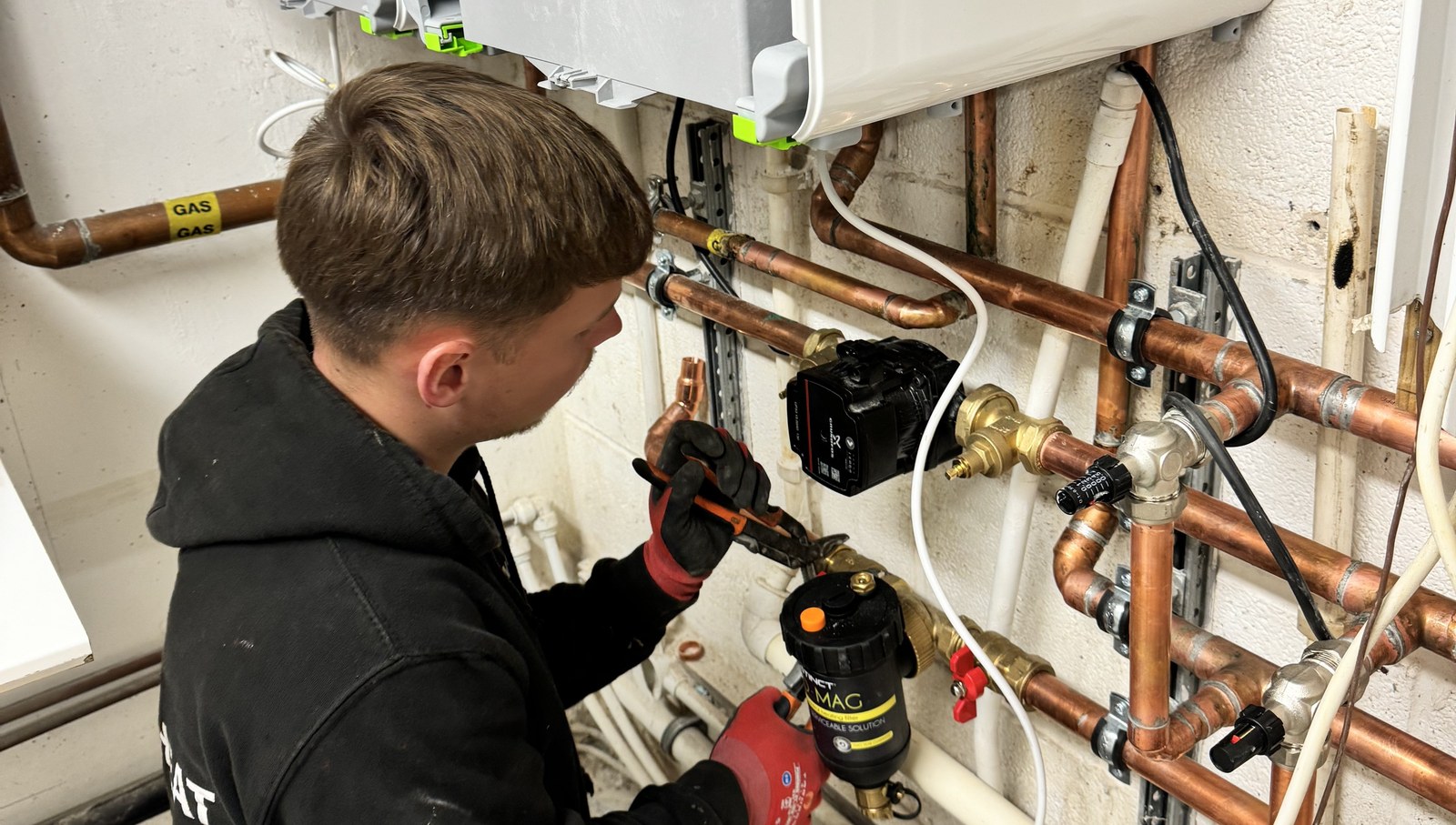 Instantheat engineer servicing pipework and filter valves
